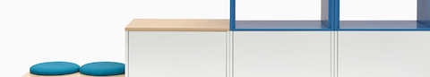 A close up of dark gray Meridian Storage lateral files, featuring two blue open shelves stacked on top. A close up of dark gray Meridian Storage lateral files, featuring two blue open shelves stacked on top.