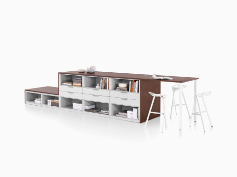 Dark brown and white Meridian Storage lateral file and bookshelf configuration with collaborative surface and three white Magis Stool One stools. Dark brown and white Meridian Storage lateral file and bookshelf configuration with collaborative surface and three white Magis Stool One stools.