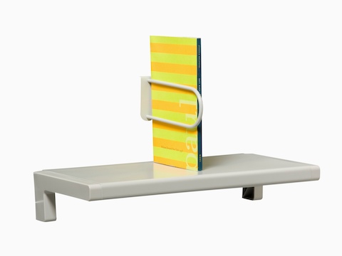 A small shelf holds an upright catalog. A small shelf holds an upright catalog.