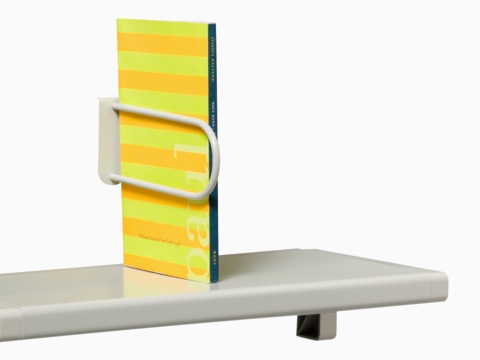 A small shelf holds an upright catalog. A small shelf holds an upright catalog.