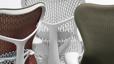 Close up of the backs for 3 Mirra 2 chairs. One is a color-block olive chair, one is an olive chair with a Butterfly back and the other is an alpine chair with a Triflex back. Close up of the backs for 3 Mirra 2 chairs. One is a color-block olive chair, one is an olive chair with a Butterfly back and the other is an alpine chair with a Triflex back.