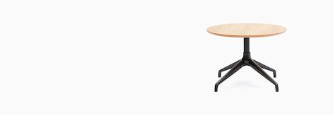 An Ali Coffee Table with a black 4-star base and circular oak veneer table top. An Ali Coffee Table with a black 4-star base and circular oak veneer table top.