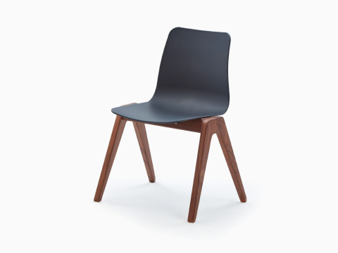 A black NaughtOne Polly Wood Chair with a walnut base, viewed at an angle. A black NaughtOne Polly Wood Chair with a walnut base, viewed at an angle.