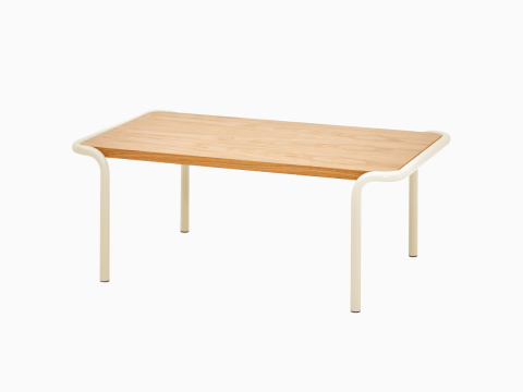 A front angled view of a rectangular Sweep Table with oak top and cream frame. A front angled view of a rectangular Sweep Table with oak top and cream frame.