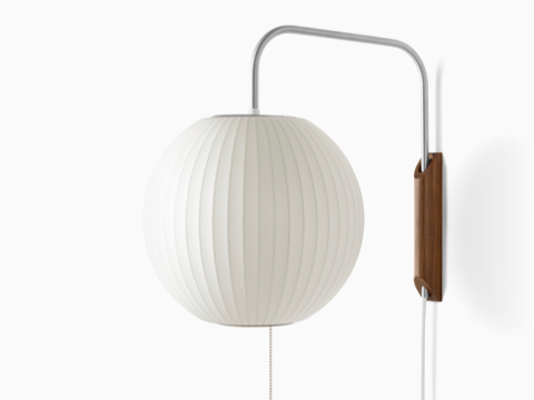 A Nelson Ball Wall Sconce with a swivel arm and walnut wall mount. A Nelson Ball Wall Sconce with a swivel arm and walnut wall mount.