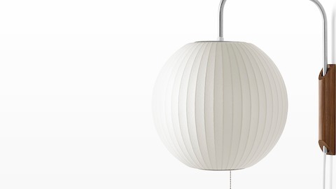 Close view of a Nelson Ball Wall Sconce with a swivel arm and walnut wall mount. Close view of a Nelson Ball Wall Sconce with a swivel arm and walnut wall mount.