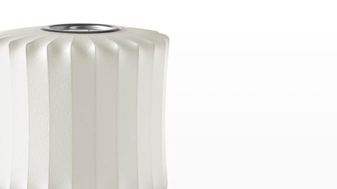 Close view of the white shade on a Nelson Lantern Tripod Lamp. Close view of the white shade on a Nelson Lantern Tripod Lamp.