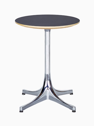 A round Nelson Pedestal Table with a black laminate top and polished aluminum base. A round Nelson Pedestal Table with a black laminate top and polished aluminum base.