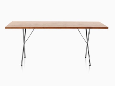 A Nelson X-Leg Table with a light veneer top and chrome legs, viewed from the long side. A Nelson X-Leg Table with a light veneer top and chrome legs, viewed from the long side.