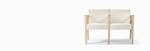 A front view of a Brava 863 two-seat multiple and tandem chair with intervening arms and legs upholstered in white textile with solid maple arms and legs. A front view of a Brava 863 two-seat multiple and tandem chair with intervening arms and legs upholstered in white textile with solid maple arms and legs.