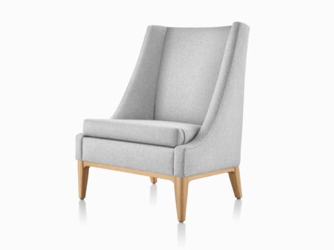Angled front view of an Iris Lounge Chair in a light gray textile with an oak base. Angled front view of an Iris Lounge Chair in a light gray textile with an oak base.