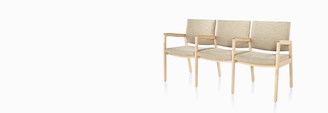 A three-quarter view of Monarch Multiple Seating three-seater with intervening arms and legs in tan textile with solid hardwood frame. A three-quarter view of Monarch Multiple Seating three-seater with intervening arms and legs in tan textile with solid hardwood frame.