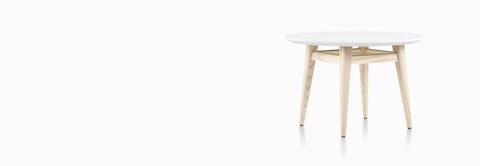 Three-quarter view of Palisade Side Table with white surface and wood legs. Three-quarter view of Palisade Side Table with white surface and wood legs.