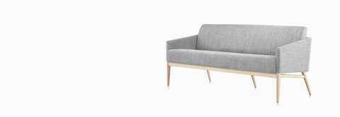 Three-quarter view of Palisade Sofa in gray fabric with wood legs. Three-quarter view of Palisade Sofa in gray fabric with wood legs.