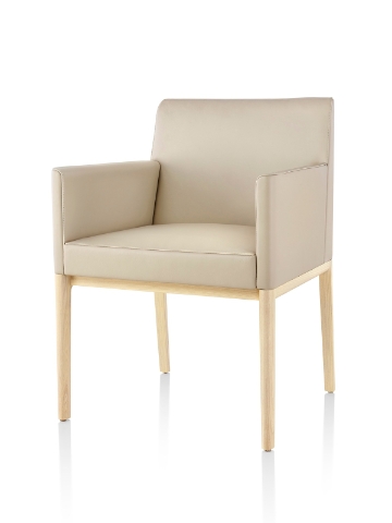 Tan Nessel Chair with arms and light wood base, viewed from the front at an angle. Tan Nessel Chair with arms and light wood base, viewed from the front at an angle.