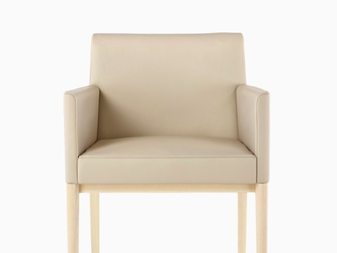 Tan Nessel Chair with arms and light wood base, viewed from the front. Tan Nessel Chair with arms and light wood base, viewed from the front.