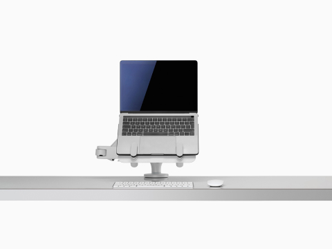 Front view of an open laptop raised and supported by an Ollin Laptop and Tablet Mount connected to an Ollin Monitor Arm. Front view of an open laptop raised and supported by an Ollin Laptop and Tablet Mount connected to an Ollin Monitor Arm.
