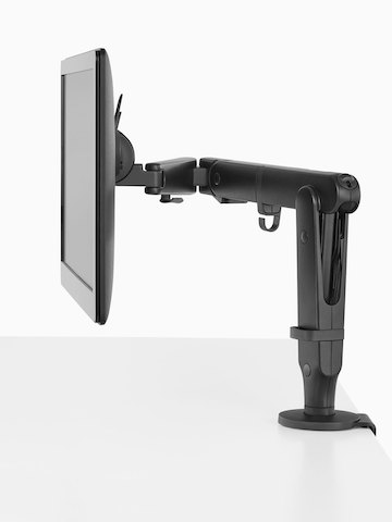 Profile view of a monitor attached to a black Ollin Monitor Arm. Profile view of a monitor attached to a black Ollin Monitor Arm.