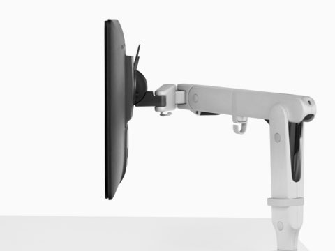 Profile view of a monitor attached to a white Ollin Monitor Arm. Profile view of a monitor attached to a white Ollin Monitor Arm.