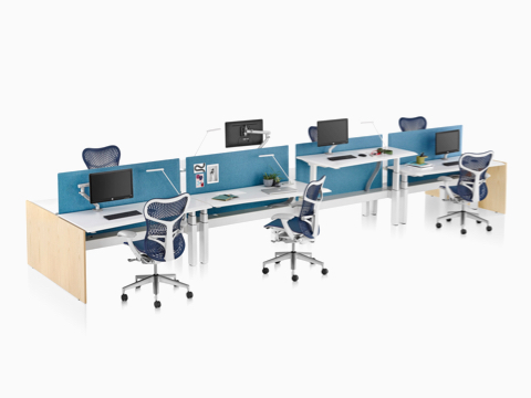 A Renew Link standing desk system with white work surfaces, blue fabric divider panel, and blue Mirra 2 office chairs. One of the eight desks is raised to standing height. A Renew Link standing desk system with white work surfaces, blue fabric divider panel, and blue Mirra 2 office chairs. One of the eight desks is raised to standing height.