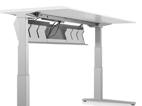 The underside of a Renew Sit-to-Stand Table, showing the cord trough in open position. The underside of a Renew Sit-to-Stand Table, showing the cord trough in open position.