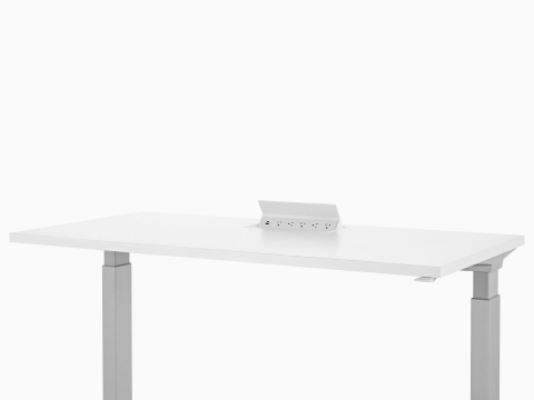 Logic power source with USB-A port, USB-C port, and five A/C power outlets embedded into white height adjustable table. Logic power source with USB-A port, USB-C port, and five A/C power outlets embedded into white height adjustable table.