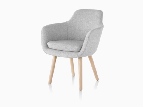 A light gray Saiba Side Chair, featuring an upholstered bucket seat and wood legs, viewed from a 45-degree angle. A light gray Saiba Side Chair, featuring an upholstered bucket seat and wood legs, viewed from a 45-degree angle.