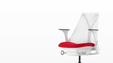 White Sayl office chair with suspension back and red upholstered seat, viewed from a 45-degree angle. White Sayl office chair with suspension back and red upholstered seat, viewed from a 45-degree angle.