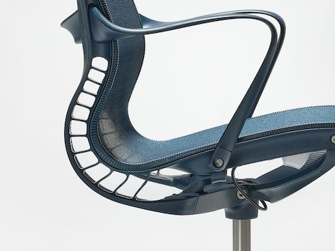 A close-up side view of a Setu chair with arms in nightfall blue. A close-up side view of a Setu chair with arms in nightfall blue.