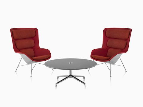 Two red and gray Striad High-Back Lounge Chairs with Striad Table with concrete quartz surface. Two red and gray Striad High-Back Lounge Chairs with Striad Table with concrete quartz surface.