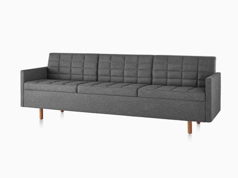 Dark gray Tuxedo Classic sofa with wood legs, viewed from the front on an angle. Dark gray Tuxedo Classic sofa with wood legs, viewed from the front on an angle.