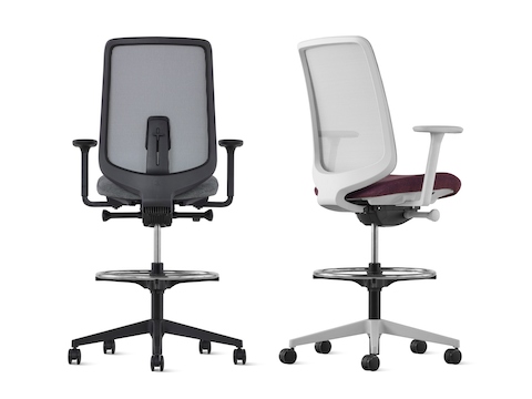 Back view of a black Verus Stool with suspension back and a back angled view of a gray Verus Stool upholstered in purple with suspension back. Back view of a black Verus Stool with suspension back and a back angled view of a gray Verus Stool upholstered in purple with suspension back.