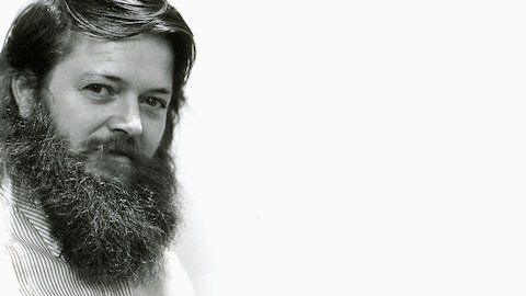 A black and white headshot of designer Ray Wilkes. Viewed at a three-quarter front angle. A black and white headshot of designer Ray Wilkes. Viewed at a three-quarter front angle.