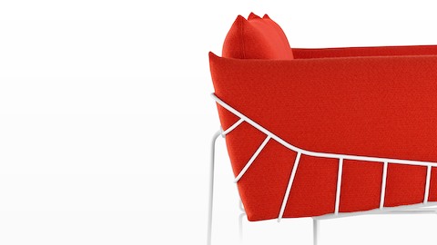 Profile view of a red Wireframe lounge chair. Profile view of a red Wireframe lounge chair.