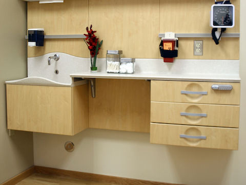 A clinic setup showing a splashless sink, cantilevering, and various cabinets. A clinic setup showing a splashless sink, cantilevering, and various cabinets.