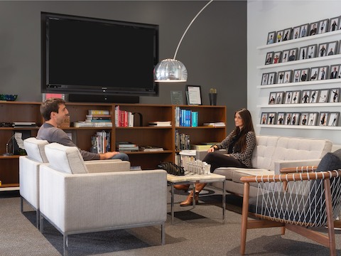 A man and a woman meeting in a casual lounge space. A man and a woman meeting in a casual lounge space.