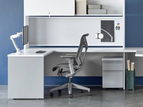 White and gray Canvas Metal Desks with overhead storage, peninsula surface, and gray Cosm Chairs. White and gray Canvas Metal Desks with overhead storage, peninsula surface, and gray Cosm Chairs.