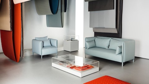 Blue ColourForm seating beneath hanging textiles of various colors. Select to go to an article about an exhibit featuring designers Scholten & Baijings. Blue ColourForm seating beneath hanging textiles of various colors. Select to go to an article about an exhibit featuring designers Scholten & Baijings.