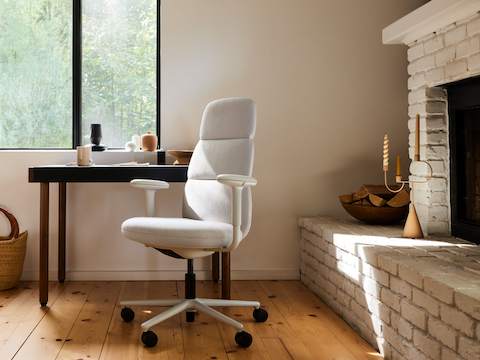 An Asari high-back chair at a Leatherwrap Desk in a home office environment. An Asari high-back chair at a Leatherwrap Desk in a home office environment.
