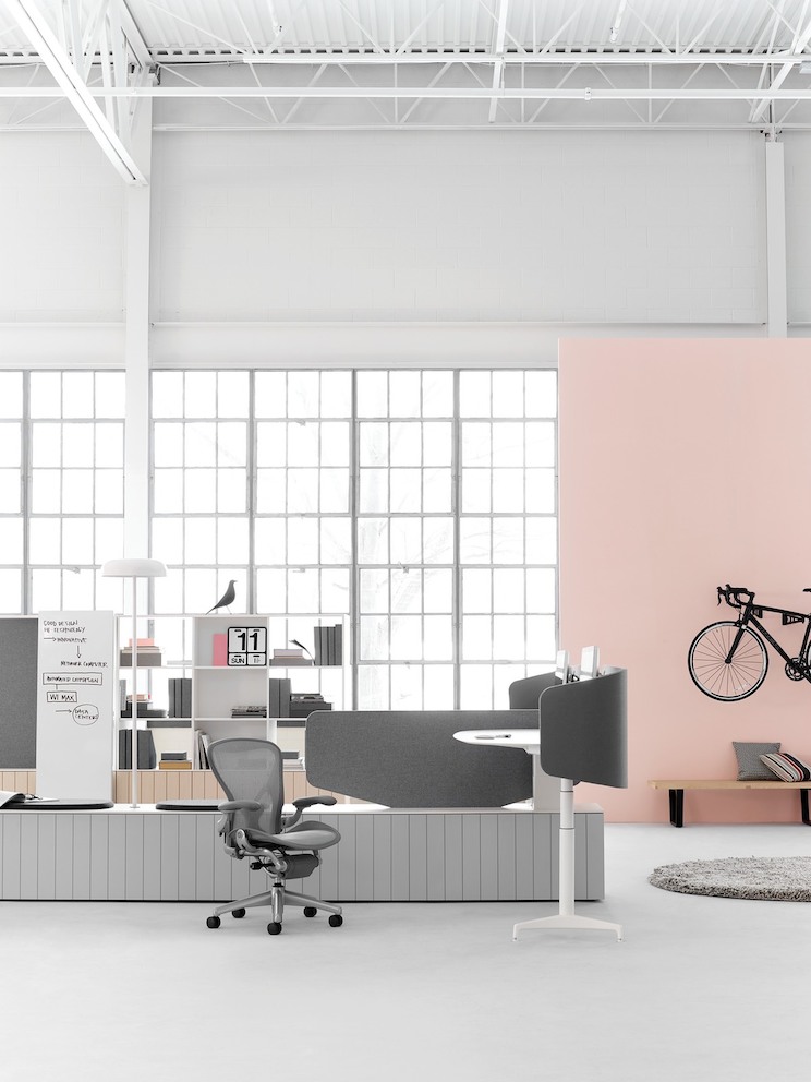 A detail of a Clubhouse setting comprised of a Double L-Desk and Full Display (partially visible), as well as Upper Shelving in the background. A detail of a Clubhouse setting comprised of a Double L-Desk and Full Display (partially visible), as well as Upper Shelving in the background.