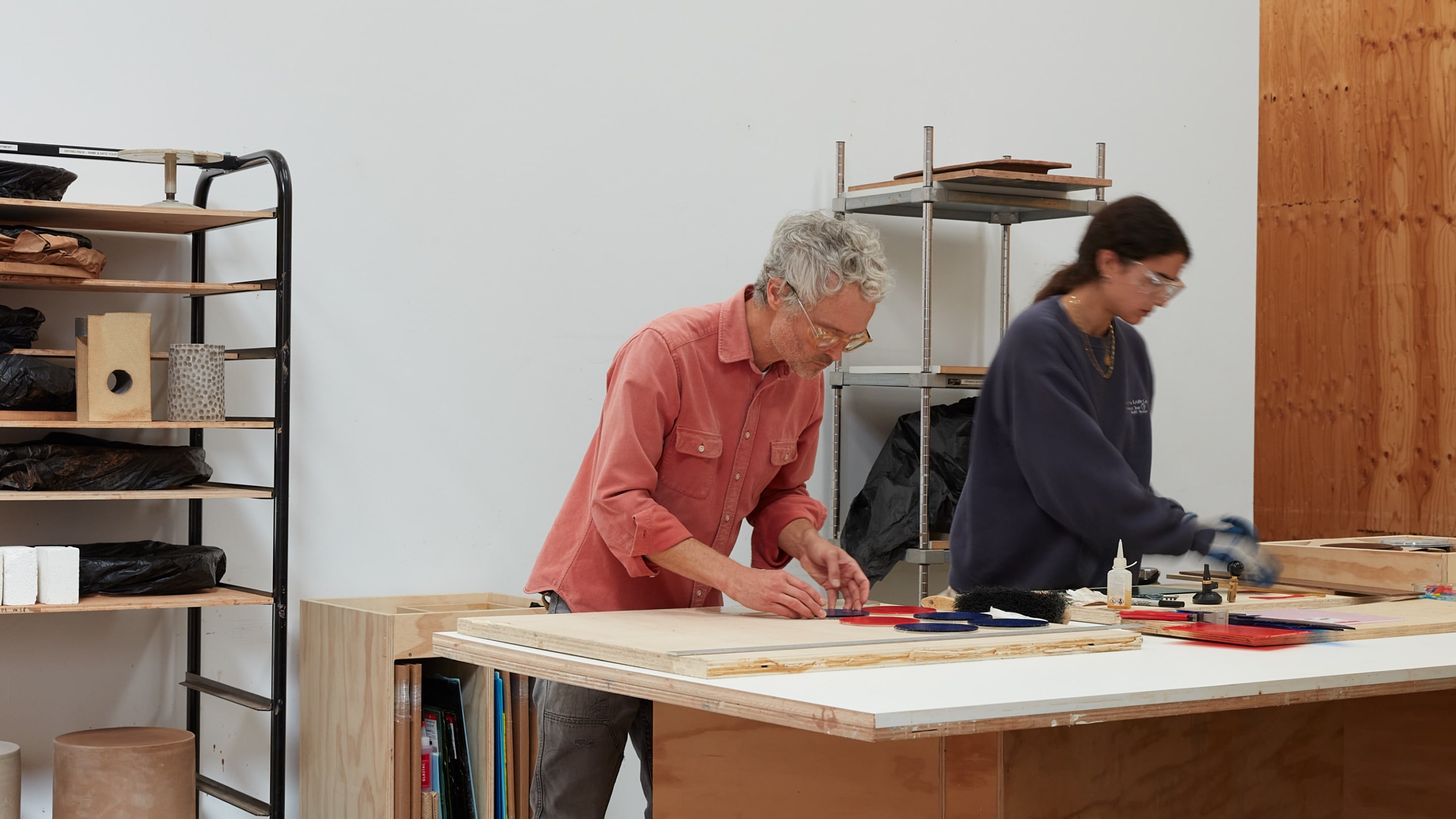 Jesse Schlesinger working with a colleague at a table in his studio. Jesse Schlesinger working with a colleague at a table in his studio.